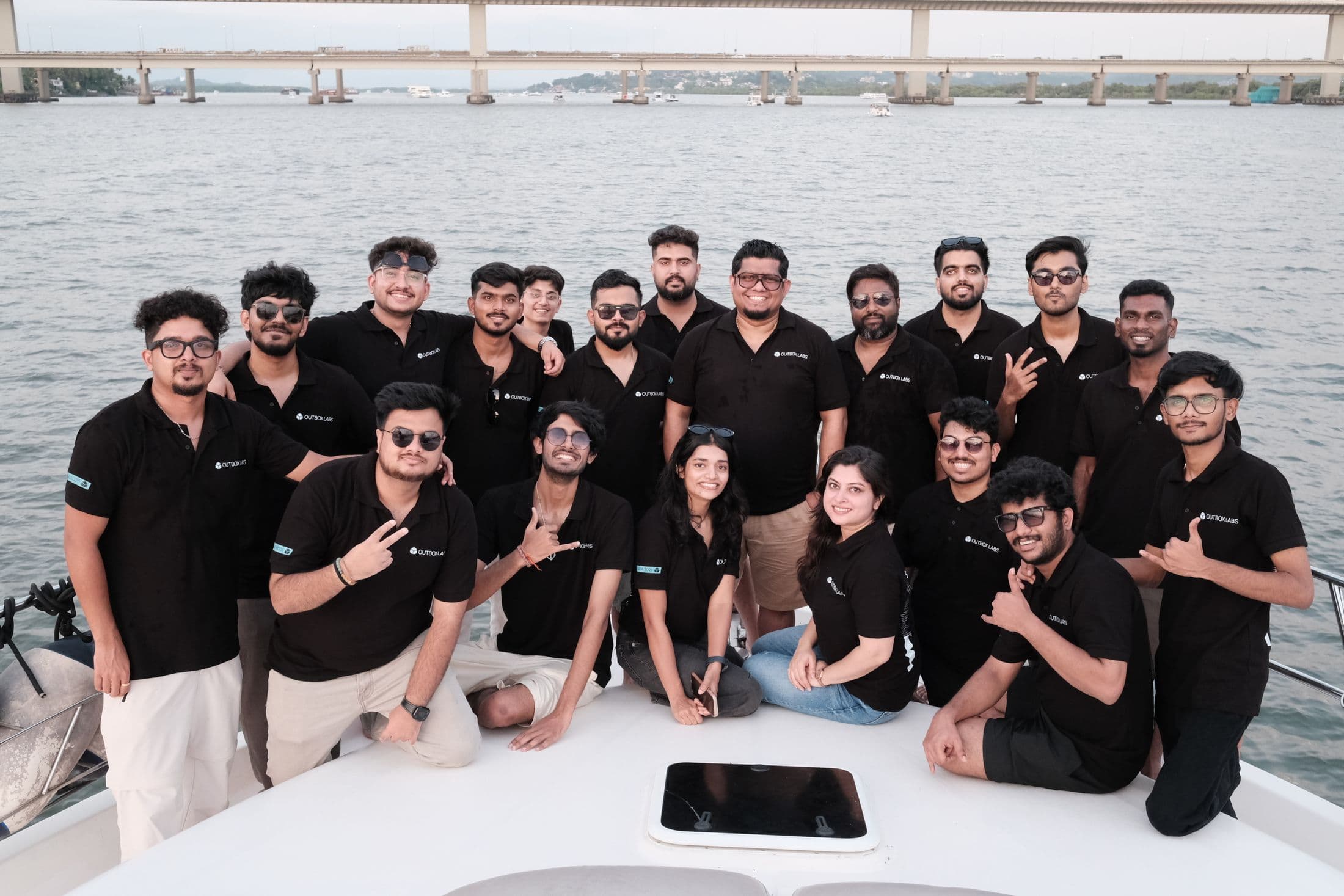 The Outbox Labs team together on the bow of a boat in Goa